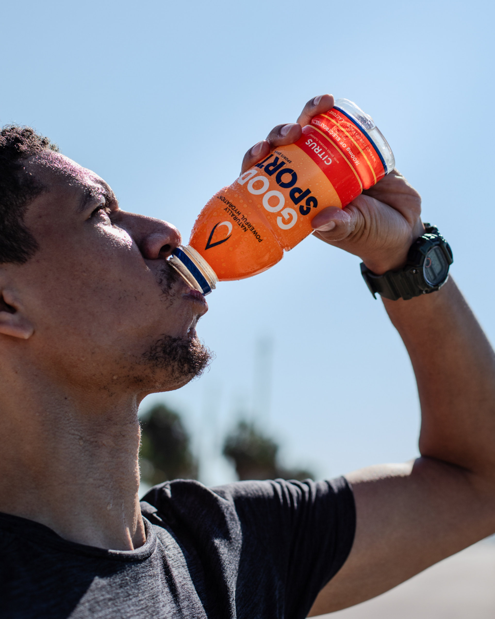 Runner drinking a bottle of GoodSport