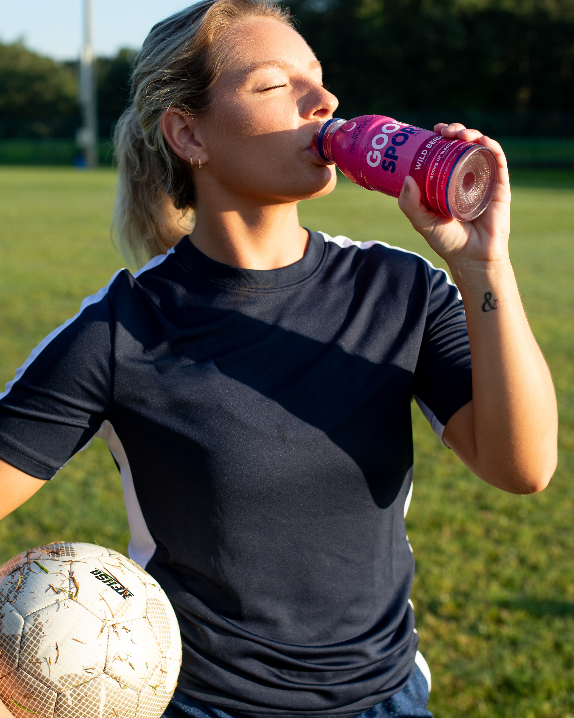 Soccer player drinking a bottle of GoodSport