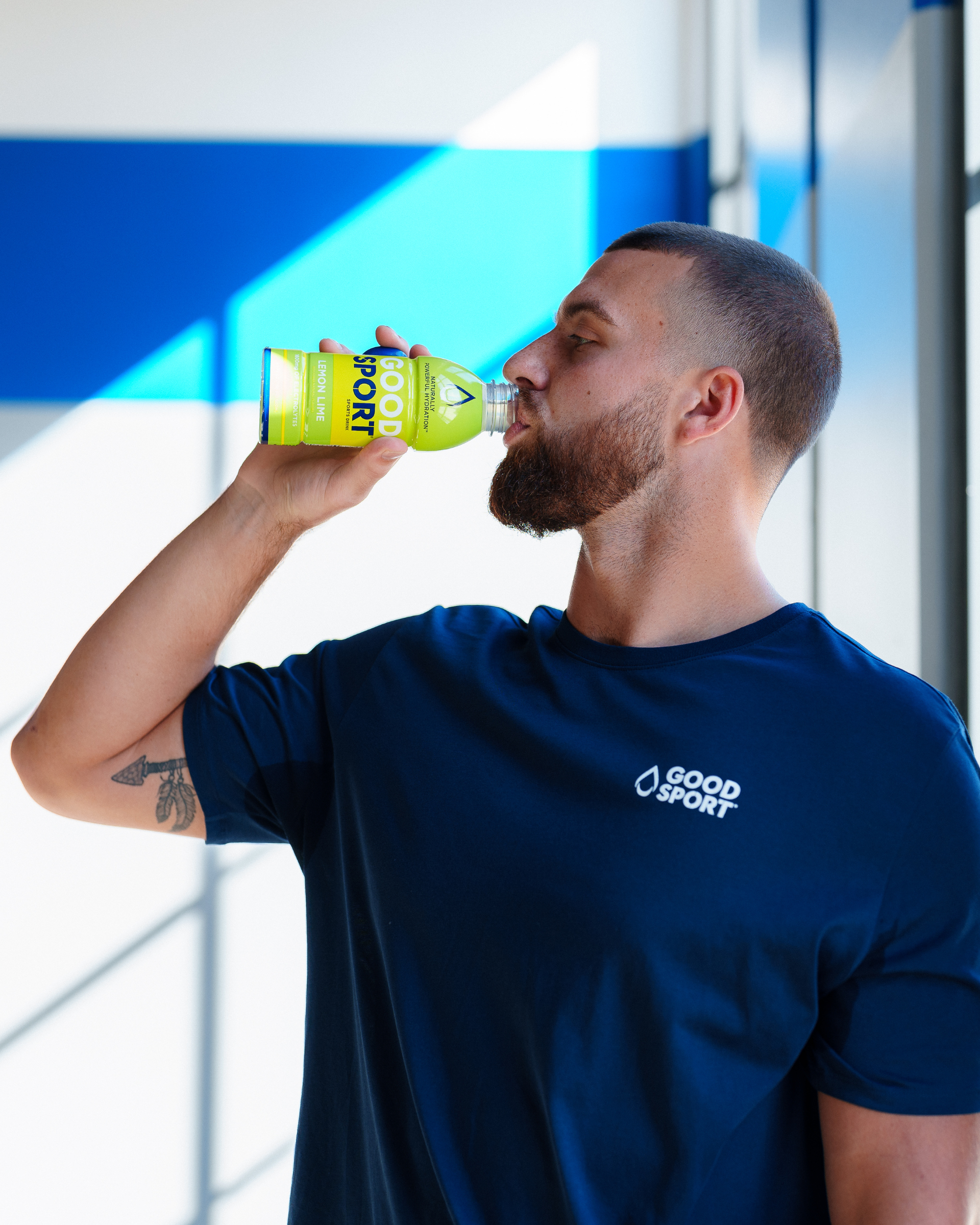 Pro Football Player Jake Ferguson drinking a bottle of GoodSport