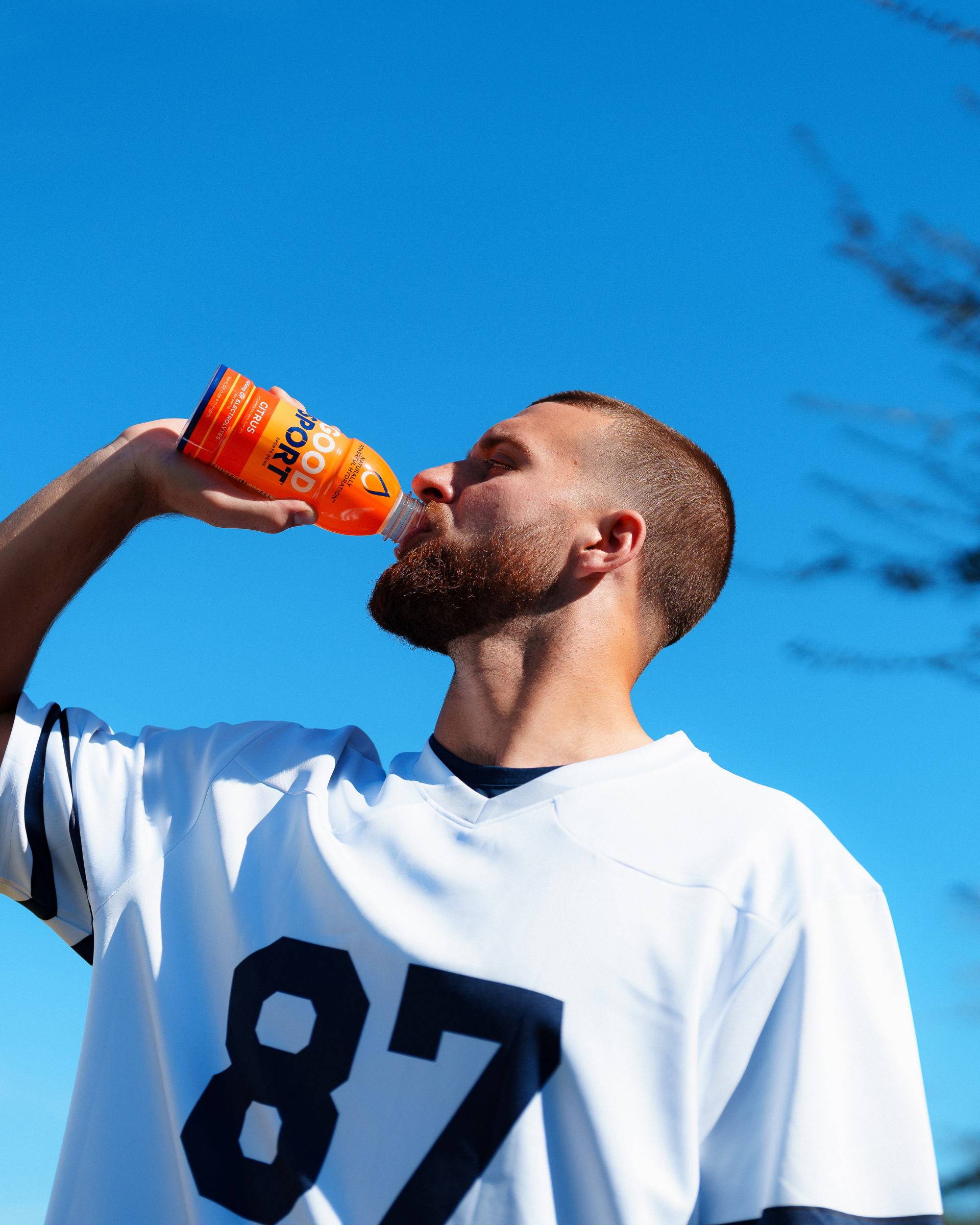 Pro football player Jake Ferguson drinking a bottle of GoodSport