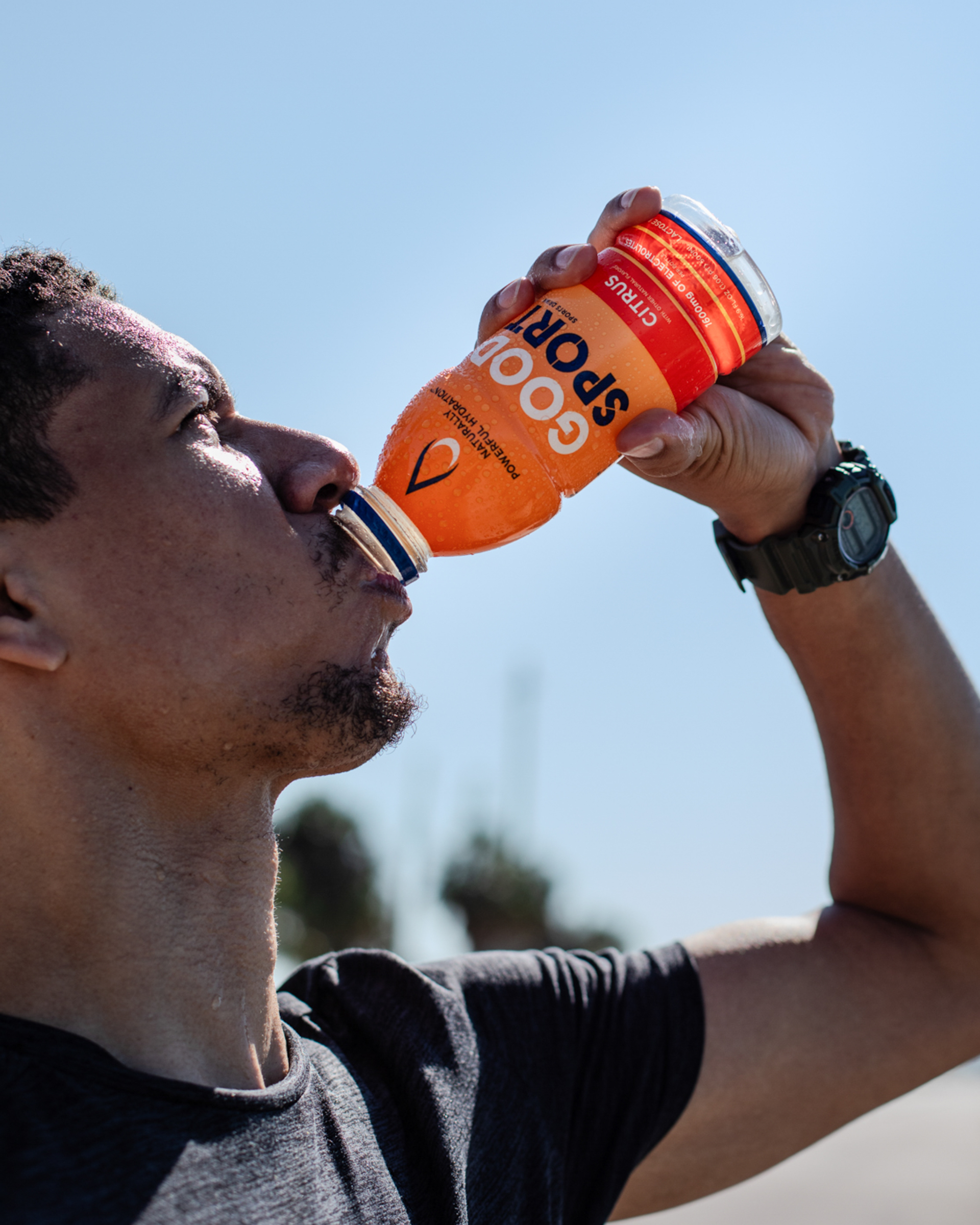 Runner drinking a bottle of GoodSport 